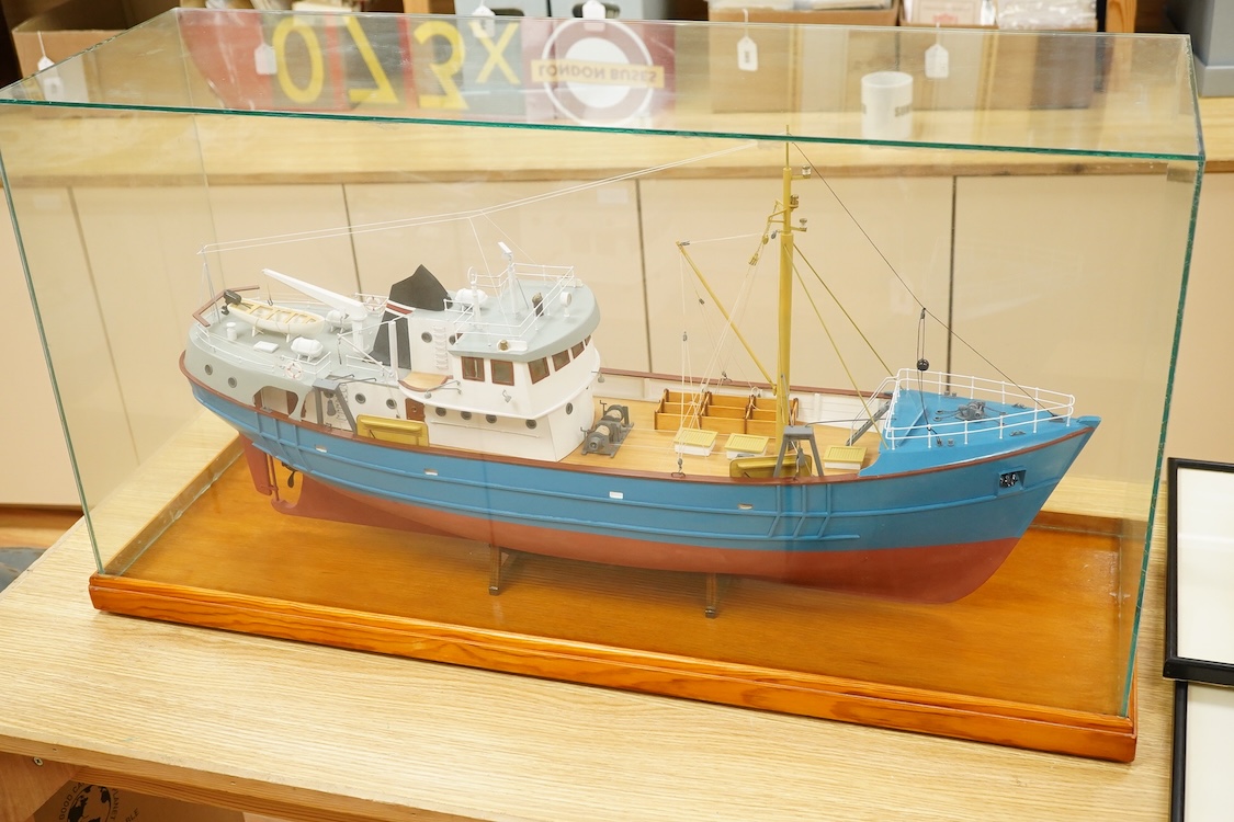 A model of a fishing trawler ship constructed from a kit by Billings Boats models, of painted wood construction, finished to a high standard with a good level of detail, presented in a glazed cabinet on a wooden base, ca
